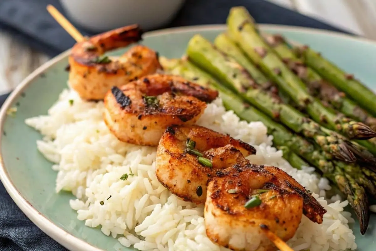 Grilled shrimp skewers served with coconut rice and asparagus